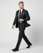 Mann im dunkelgrauen Anzug aus reiner Schurwolle in Bewegung seitlich abgebildet