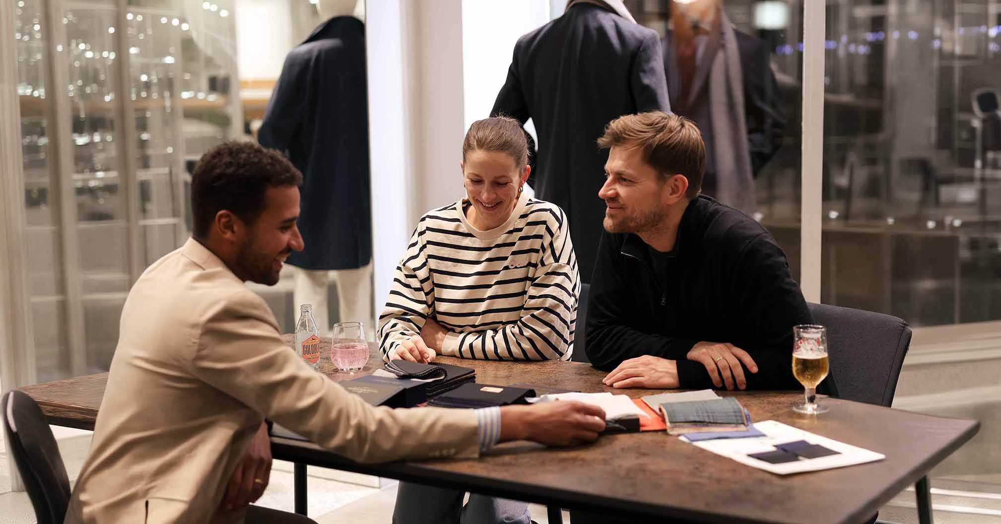 Beratungssituation eines Brautpaares hinsichtlich des Hochzeitsanzuges