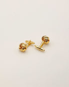 Manschettenknöpfe in gold als Set liegend