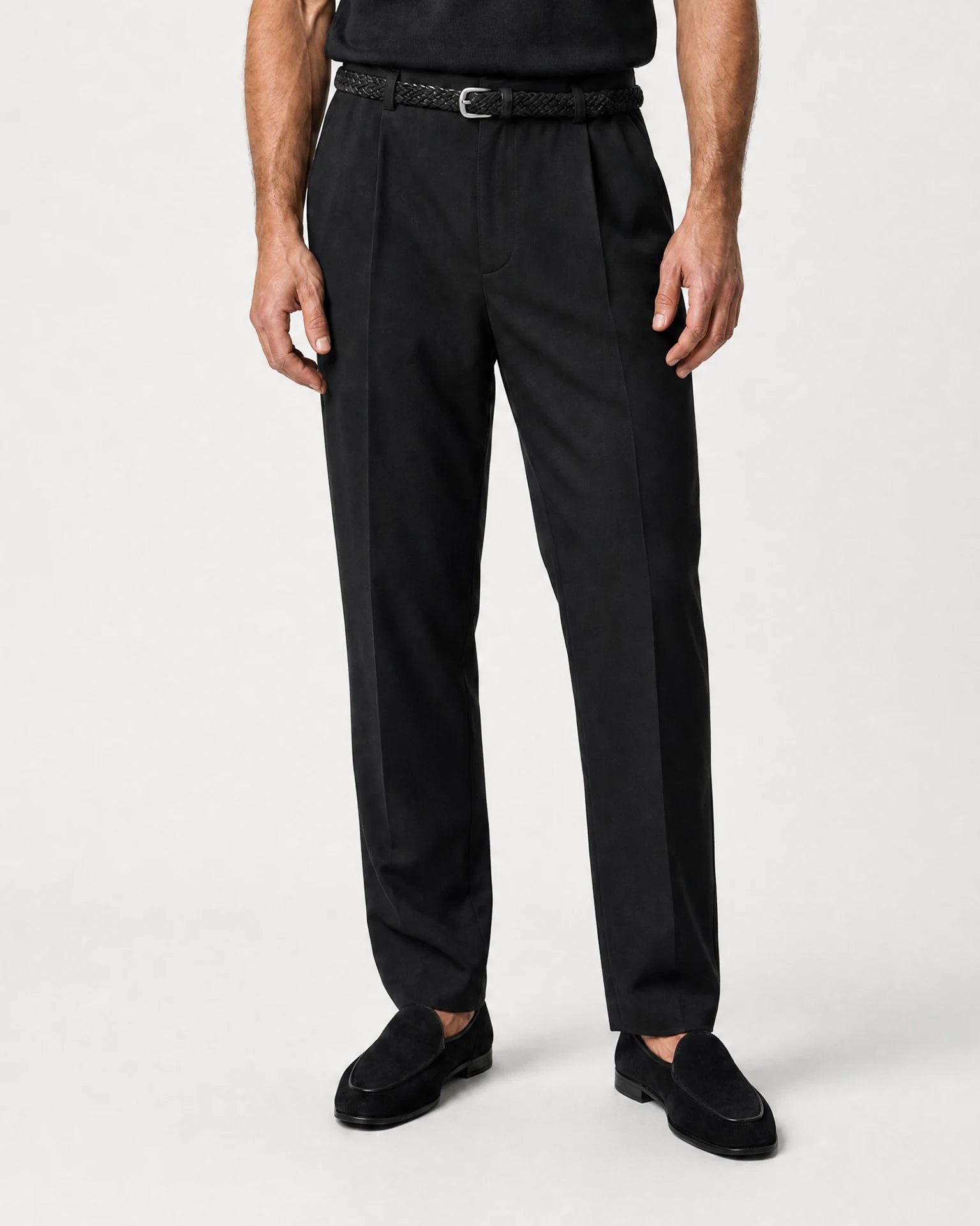 Frontale Produktansicht der schwarzen Leinenhose mit Bundfalten, geradem Bein und schwarzen Loafern.