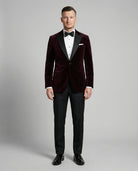 Mann im bordeauxfarbenen Samtsakko mit schwarzer Hose von vorne abgebildet